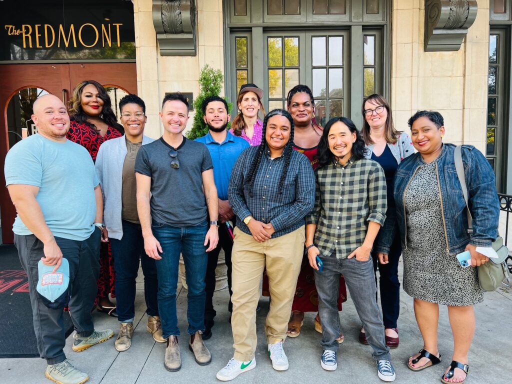 A group of board members, happily standing together for a photo.