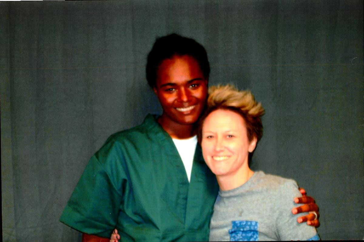 Lindsay Saunders smiles with arm around another person